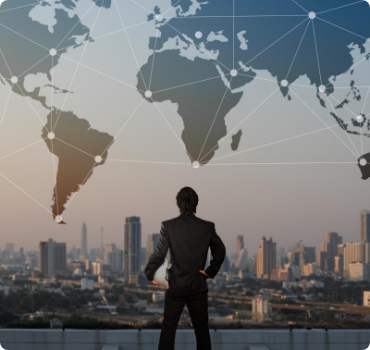 Global-Markets-scaled A man standing in front of a city skyline.